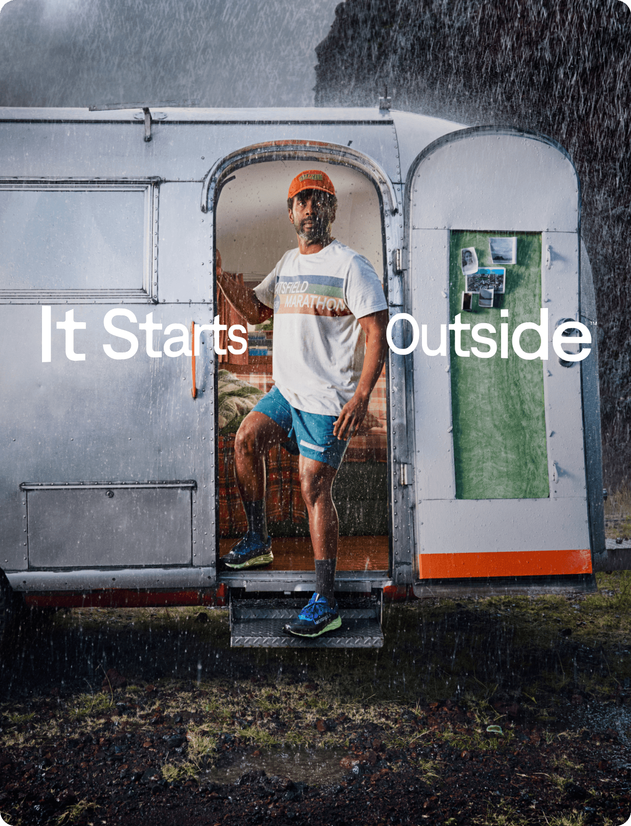 man coming out of a camper into the rain